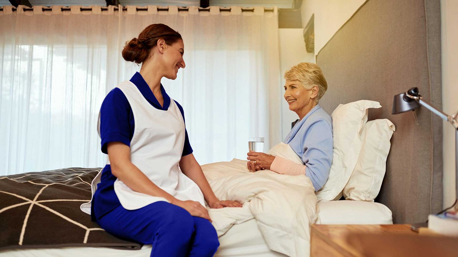 Carer providing morning care assistance to an elderly person in Woking